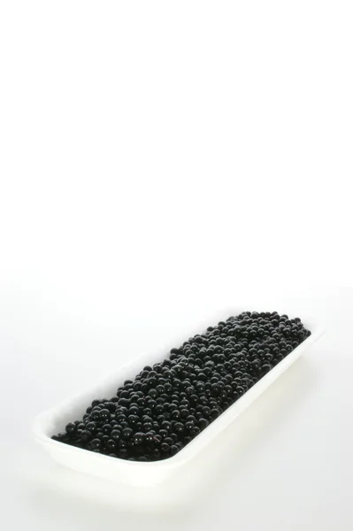Elderberries on a styrofoam container — Stock Photo, Image