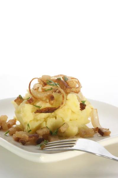 Mashed potato with onion ring and bacon — Stock Photo, Image