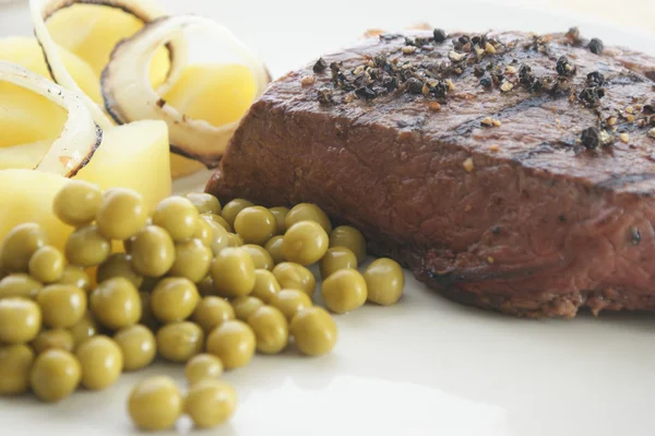 Grilled pepper steak with some pea — Stock Photo, Image