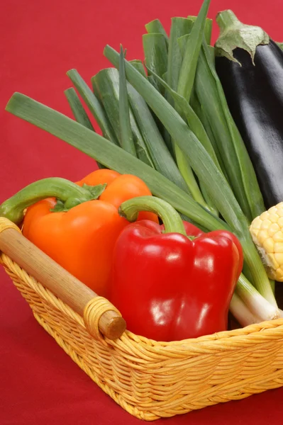 Papriku a jarní cibulky v košíku — Stock fotografie