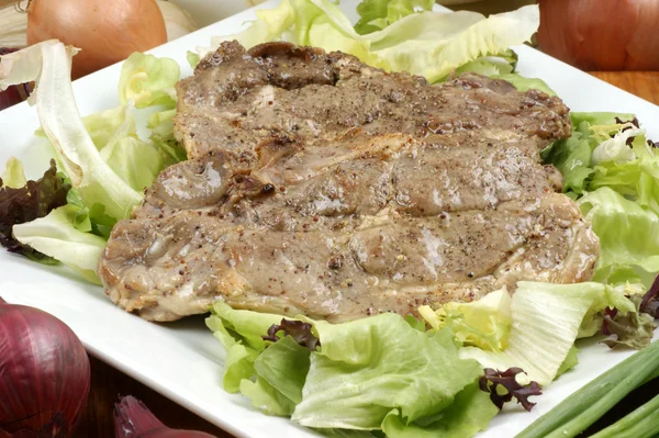 Stock image Raw organic pork chop and salad