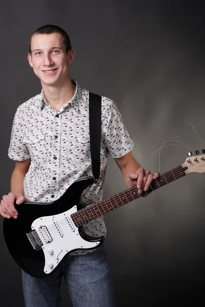 Teenager holding the guitar — Stock Photo, Image