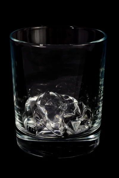 Single glass with ice cube — Stock Photo, Image