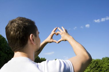 Fingers in the sky in the form of heart clipart