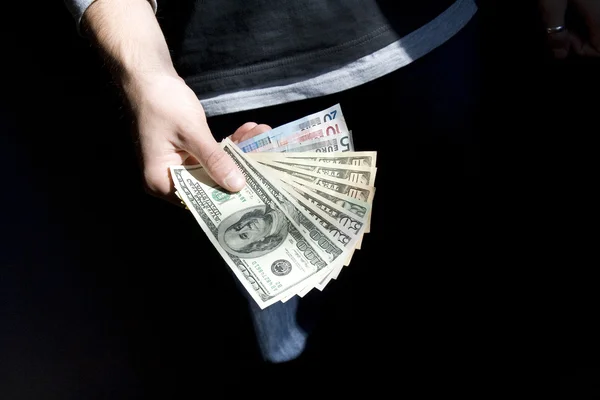 Dollars and euro in a hand — Stock Photo, Image
