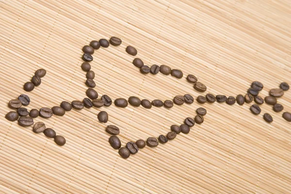 Coração de café perfurado por uma seta — Fotografia de Stock