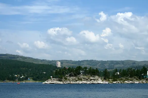 Stock image Clouds and pines