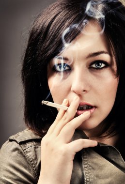 Woman smoking a cigarette clipart