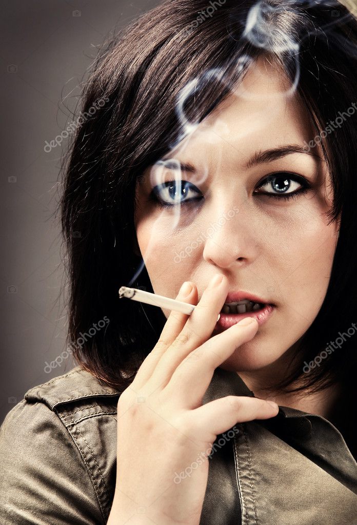 Woman smoking a cigarette Stock Photo by ©anatema 1747562