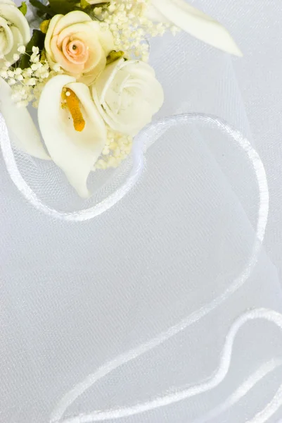 Wedding flowers over veil — Stock Photo, Image