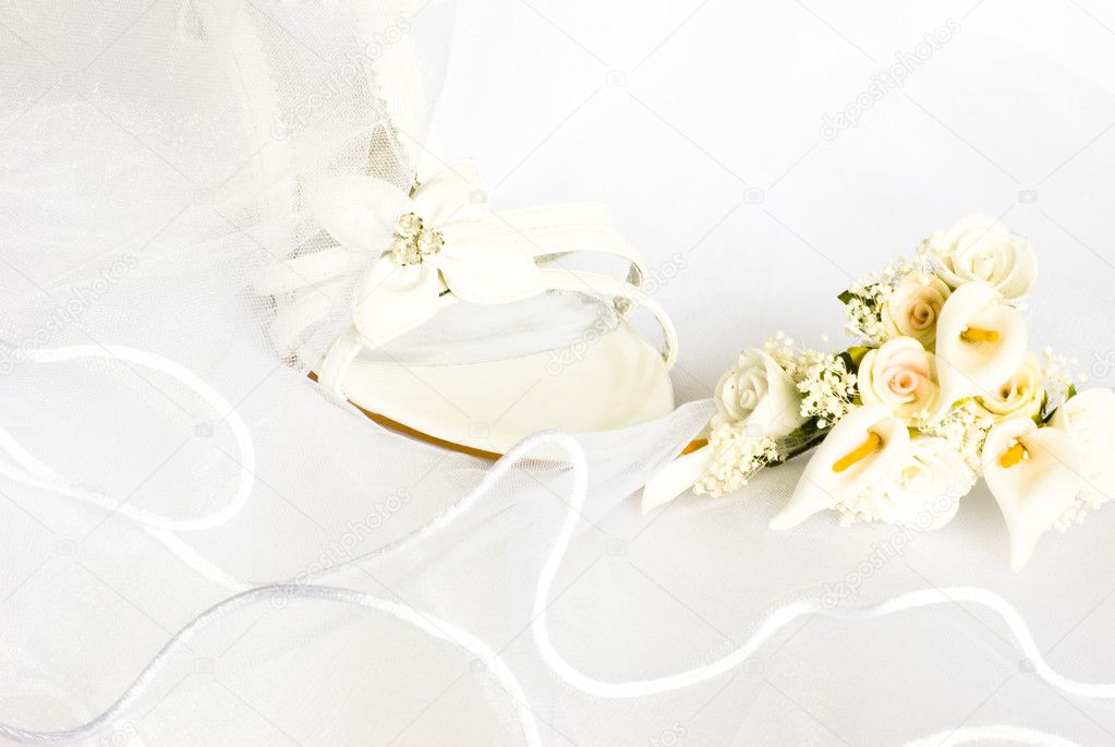 Wedding sandals and flowers over veil