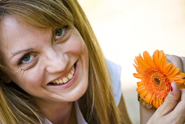 Beautiful young woman with flower — Stock Photo, Image