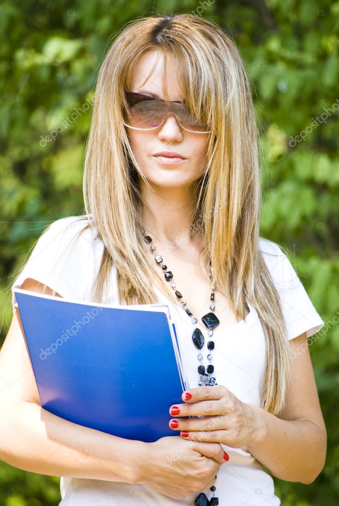 Beautiful young woman reading book