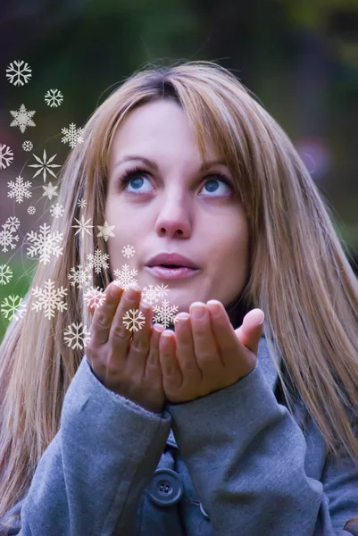Girl blowing snowflakes — Stock Photo, Image