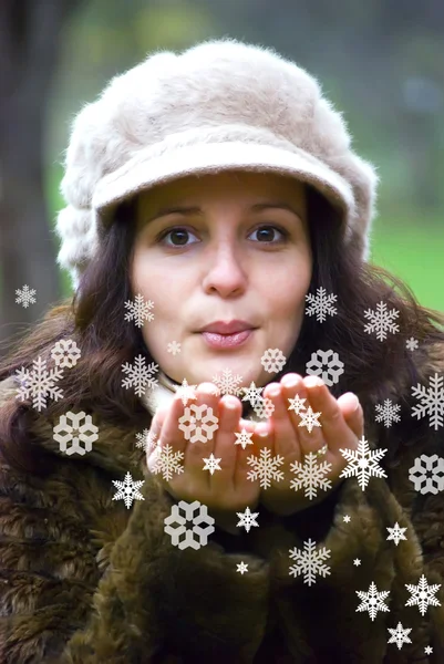 Girl blowing snowflakes — Stock Photo, Image