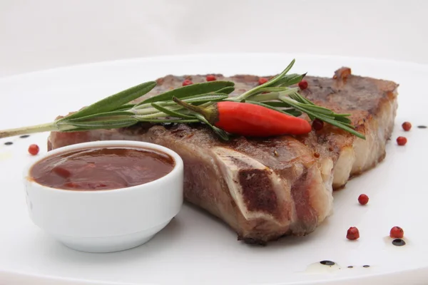Rib-eye steak resting on a white plate — Stock Photo, Image