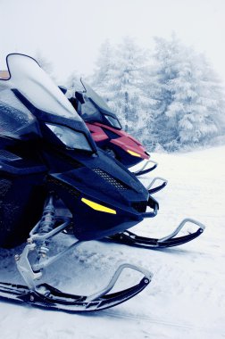 Snowmobiles in the mountains clipart