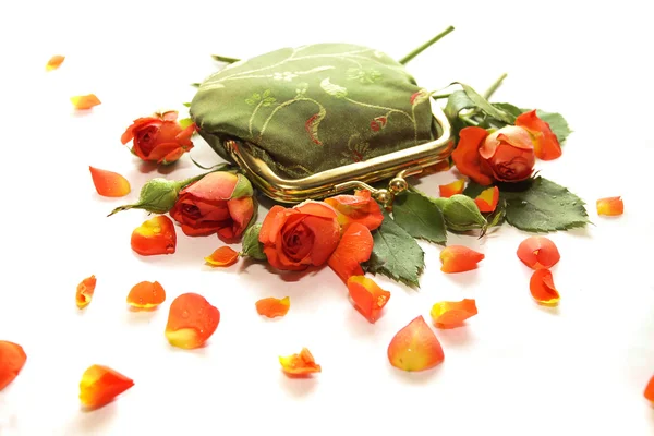 Small green purse in roses — Stock Photo, Image