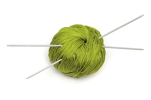 Ball of green wool with knitting needles — Stock Photo, Image