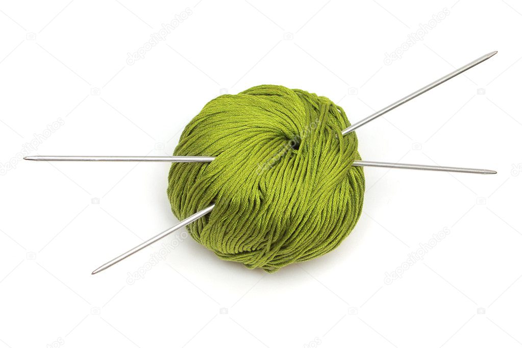 Ball of green wool with knitting needles