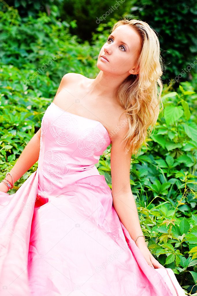 A young woman in a pink dresses