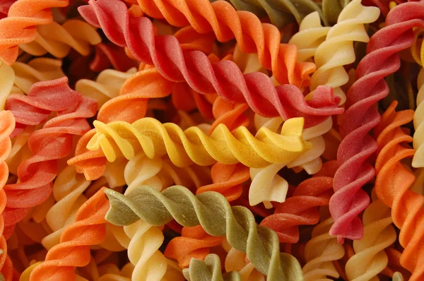 Multi colored twirls pasta background — Stock Photo, Image