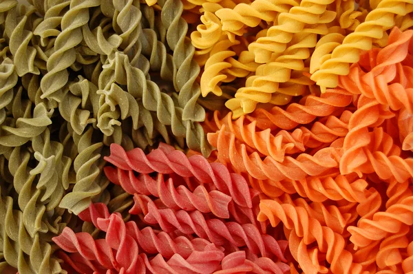 Colored twirls pasta background — Stock Photo, Image