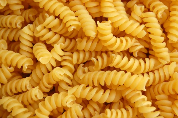 Eliche twirls pasta background — Stock Photo, Image