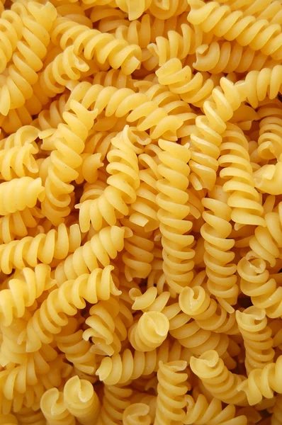 Twirls pasta background — Stock Photo, Image