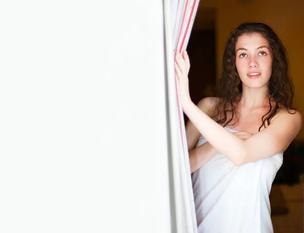 Chica en la ventana con cortina — Foto de Stock