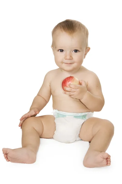Baby hält einen Apfel. — Stockfoto