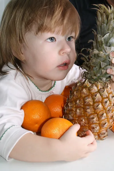 Flicka, apelsiner och ananas — Stockfoto