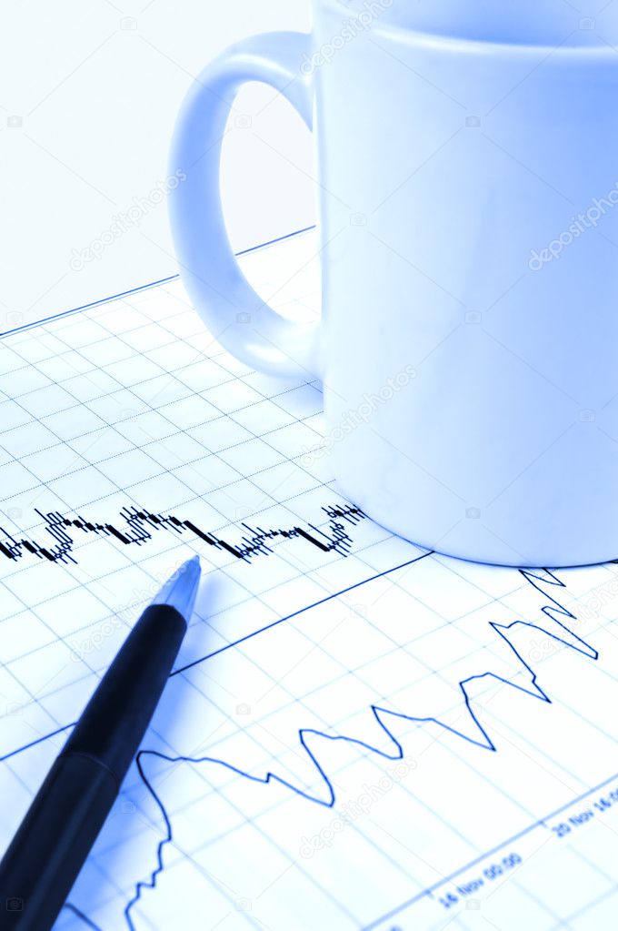 Pen and cup on stock chart