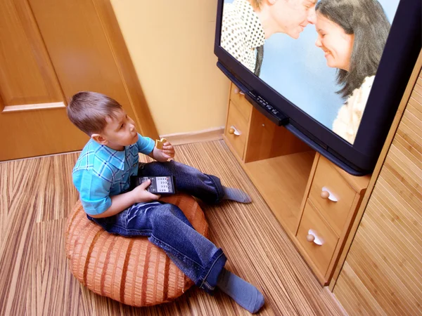 stock image Little boy watching cinema on TV