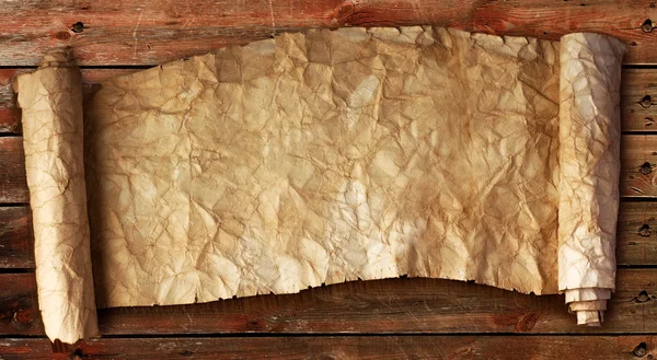 Ancient scroll against the wooden planks — Stock Photo, Image
