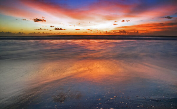 Sunset on tropical beach. Legian beach. Bali island, Indonesia