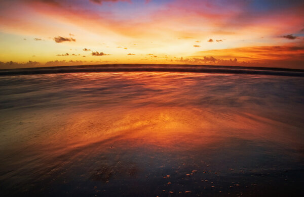 Sunset on tropical beach. Legian beach. Bali island, Indonesia