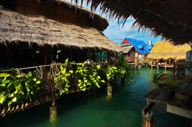 Asian Village on stilts in the sea clipart