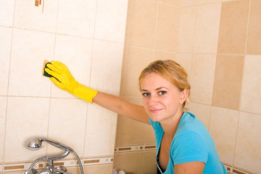 Beautiful woman washing a tile clipart