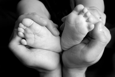 Baby's feet in daddy's hands 2 clipart