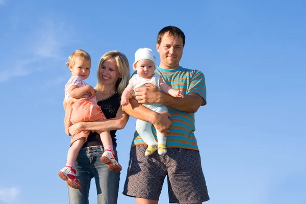 Happy family against the sky — Stock Photo, Image