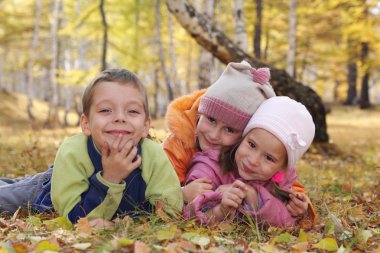 Happy children in autumn park 5 clipart