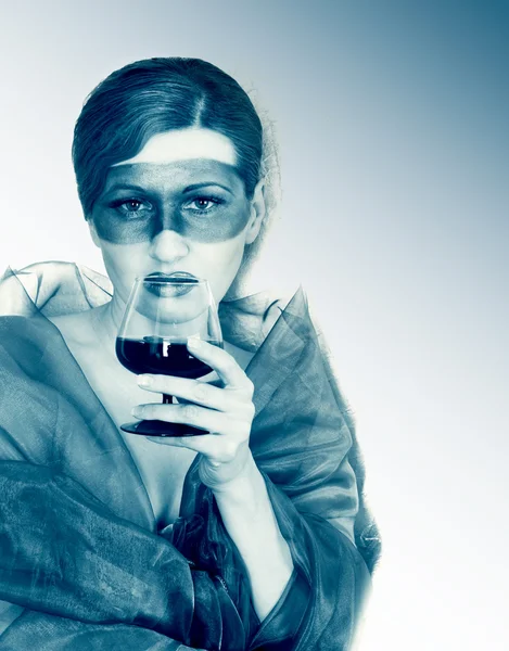 Girl in a mask with a glass — Stock Photo, Image