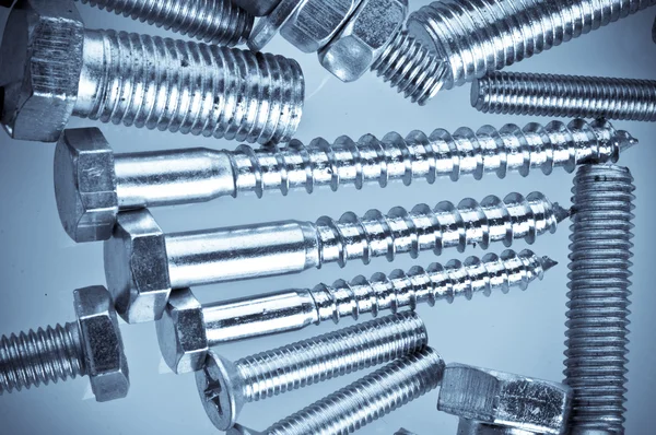 Bolts, screws, nuts. In a blue tonality — Stock Photo, Image