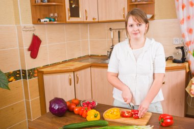 The girl cuts pepper