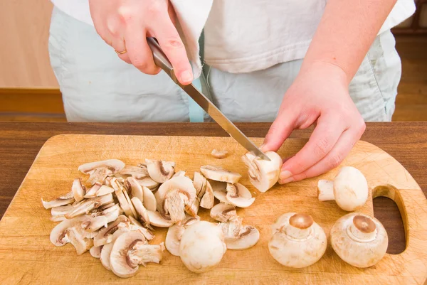 stock image The woman cuts mushrooms