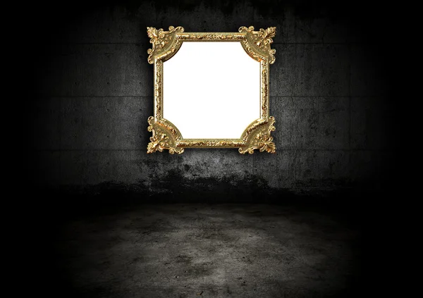 Golden frame in a dark room — Stock Photo, Image