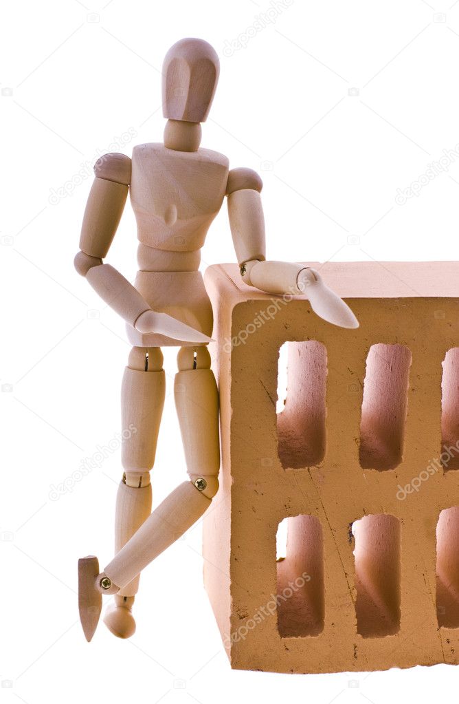 Wooden man with a brick