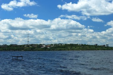 Wavy water of river over cloudy blue sky