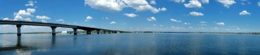 Panorama of river and long bridge clipart